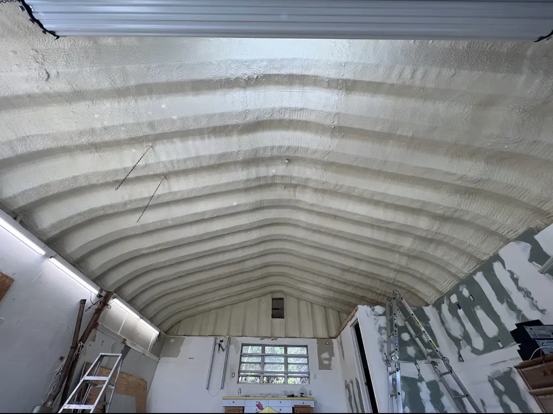 Spray polyurethane foam applied to the underside of a metal roof deck in Scio